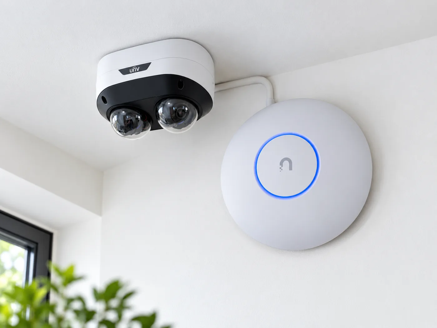 Dual-lens dome security camera and ceiling Wi-Fi access point installed in a home